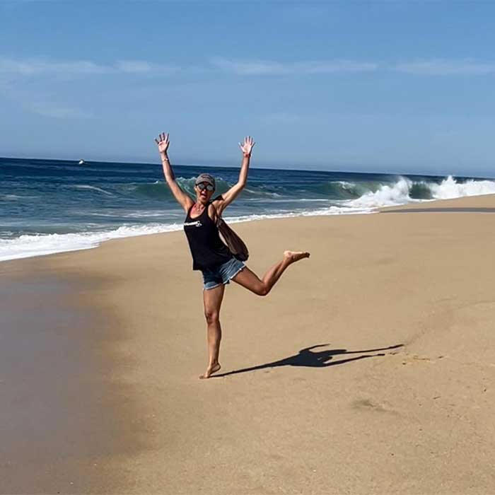 kathy jumping on a beach